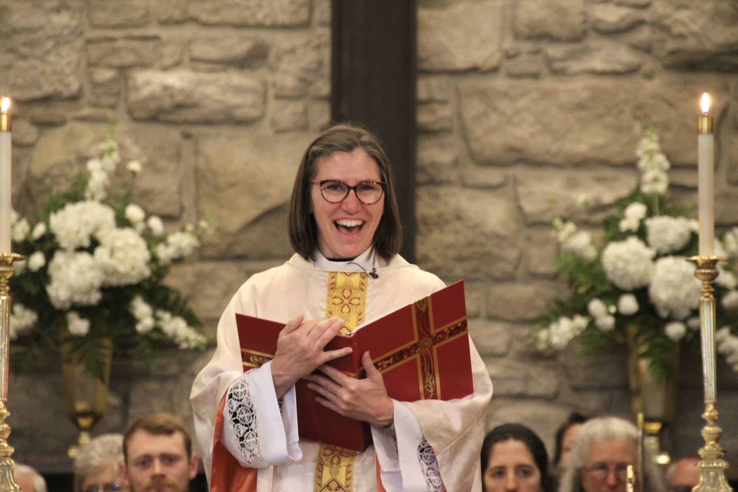 Celebrant in church robes holding a book during a service at Calvary Episcopal Church.