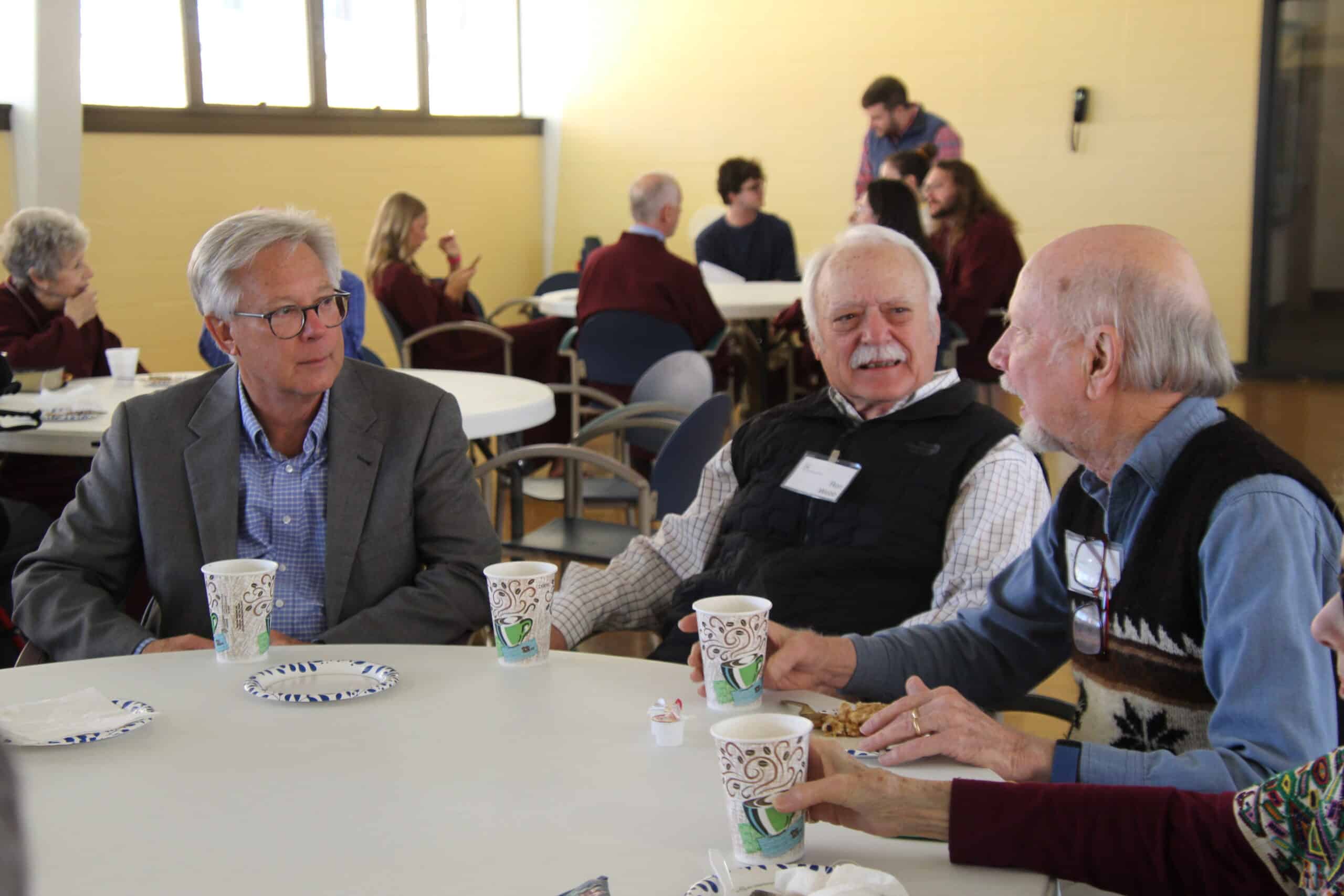 Community gathering at Calvary Episcopal Church with seniors enjoying conversation.